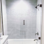 White Bathroom with a shiny glass shower door.