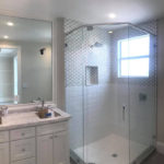 White Modern Bathroom with Glass Shower enclosure.