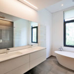 White and neutral colors in the bathroom where mirror was installed.